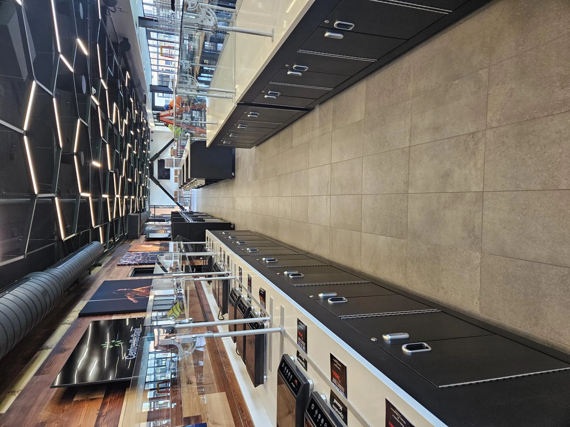 View down an aisle between two long serving counters with sneeze guards